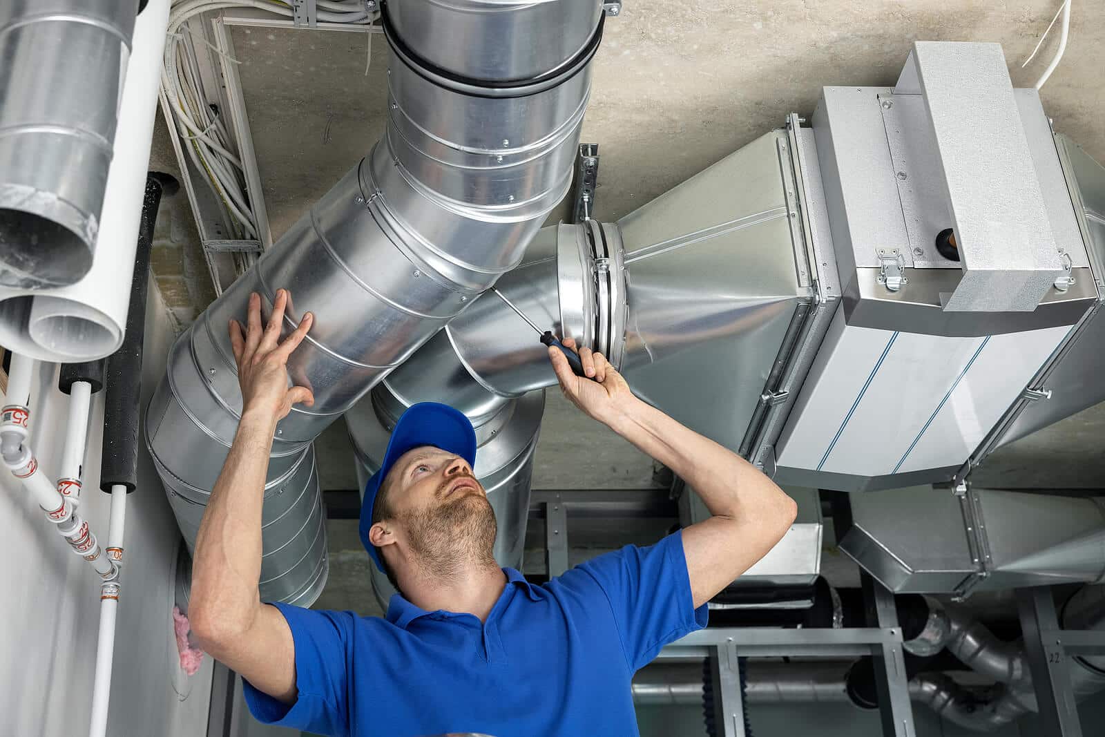 HVAC technician inspecting and repairing air ducts in San Gabriel