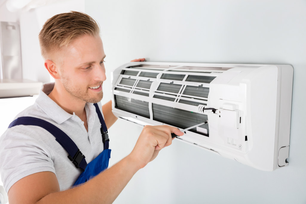 HVAC technician maintaining a ductless air conditioner in San Gabriel