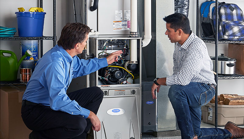 Technician evaluating a furnace for repair or replacement in San Gabriel