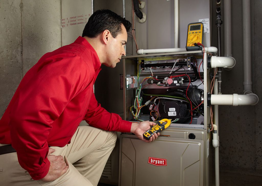 Heating technician diagnosing a furnace repair in San Gabriel