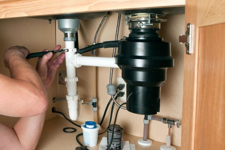 Plumber repairing a garbage disposal in San Gabriel