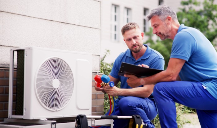 HVAC technicians installing an outdoor air conditioning unit in San Gabriel