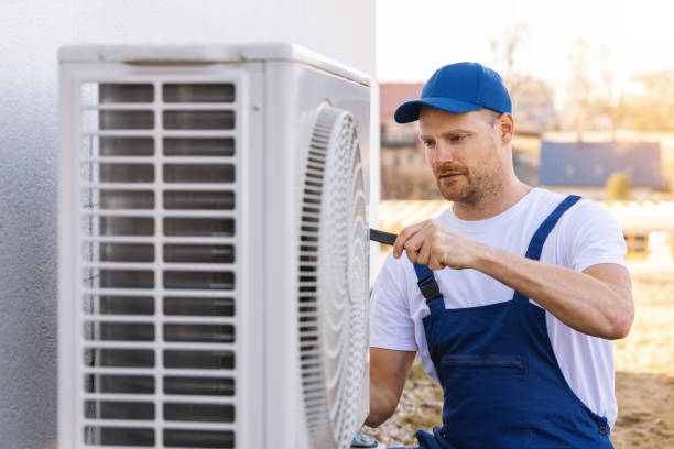 HVAC technician servicing an outdoor air conditioner in San Gabriel
