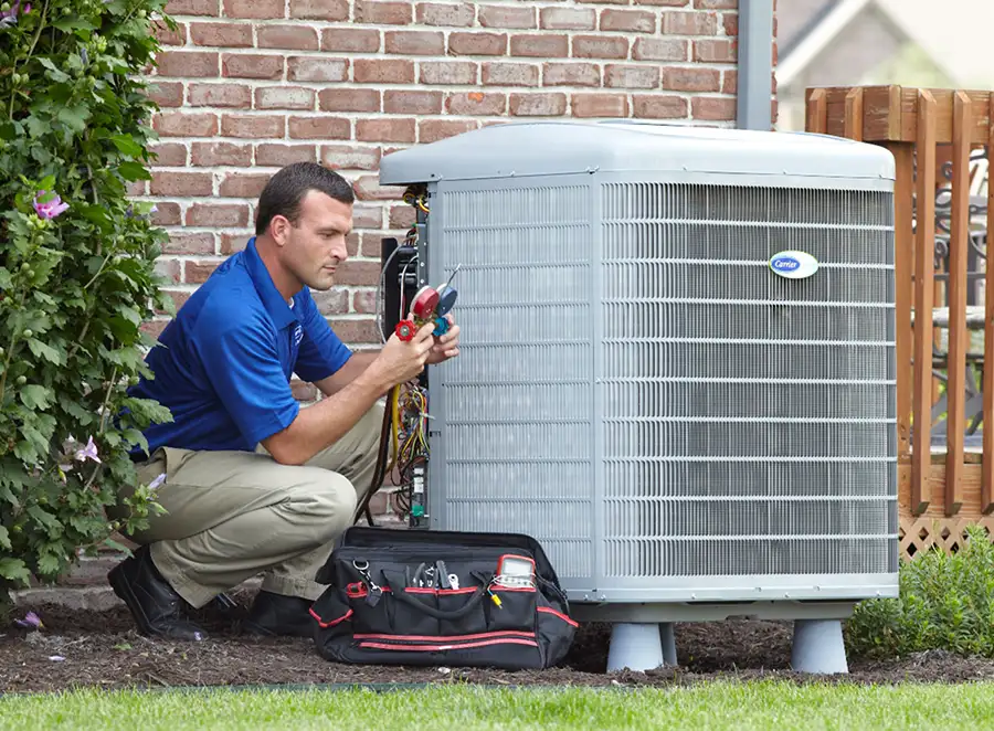 HVAC technician inspecting an outdoor AC unit in San Gabriel