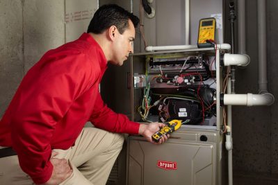 Heating technician diagnosing a furnace repair in San Gabriel