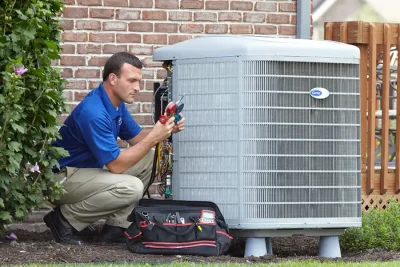 HVAC technician inspecting an outdoor AC unit in San Gabriel